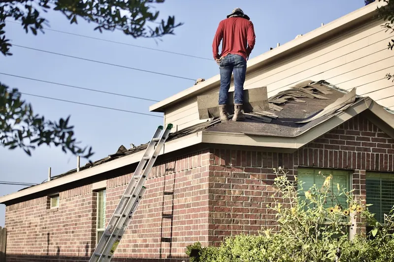 Professional roofer working on a residential roof in Hidden Acres of Fayette